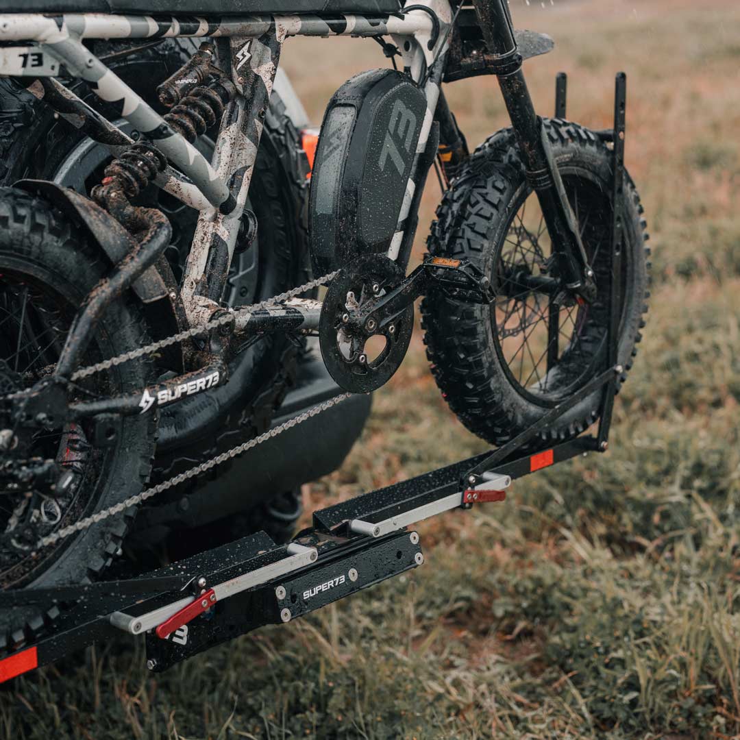 Lifestyle image of a SUPER73-R Adventure ebike on a 1UP USA x SUPER73 Bike Rack.