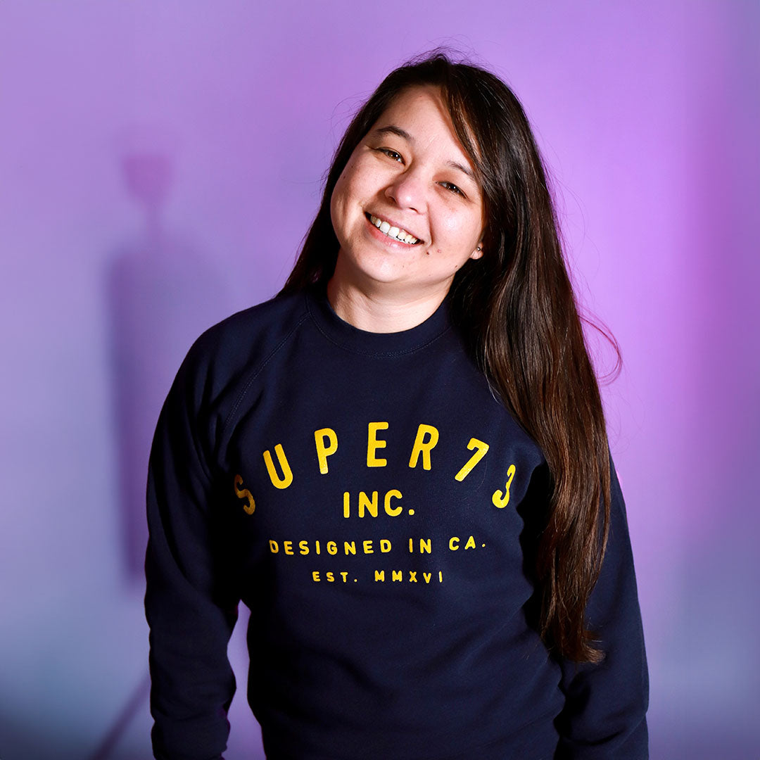 female model wearing Class of '73 Crewneck Sweatshirt in navy. @color_navy