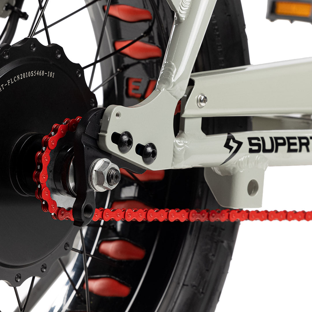 Close up shot of red chain on bike with white background. @color_red