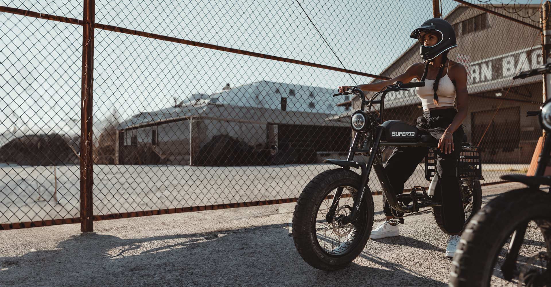 a female rider on her customized SUPER73 with side racks